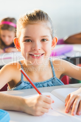 Close-up of schoolkid doing homework in classroom