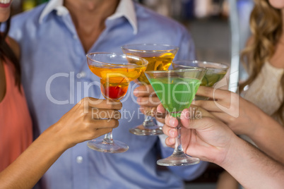 Friends toasting martini and cocktail glass