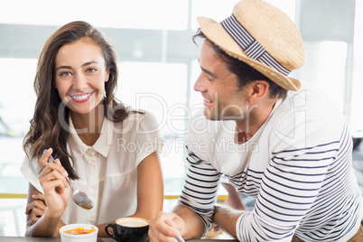 Smiling couple having dessert