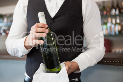 Waiter holding a bottle of wine