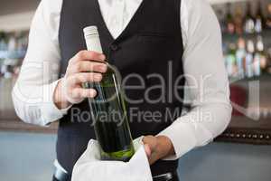 Waiter holding a bottle of wine