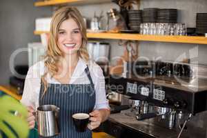 Portrait of smiling waitress making cup of coffee