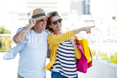 Woman with man pointing in city