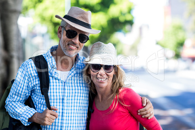 Smiling mature couple standing on sidewalk