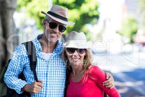 Smiling mature couple standing on sidewalk