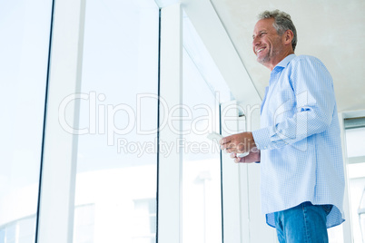 Low angle view of mature man holding phone