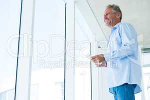 Low angle view of mature man holding phone