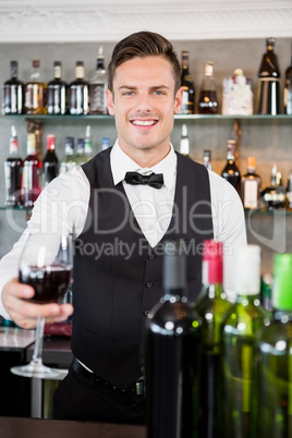 Waiter holding a glass of wine