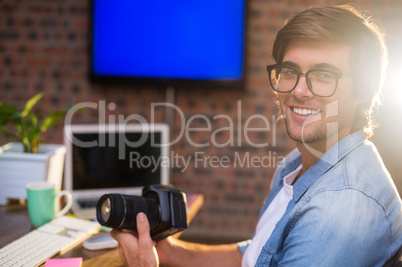 Portrait of smiling man holding camera