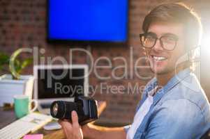 Portrait of smiling man holding camera