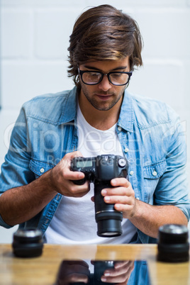 Man holding camera in office