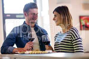 Couple holding wineglass at counter