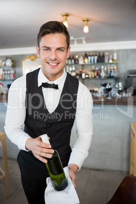 Waiter holding a bottle of wine