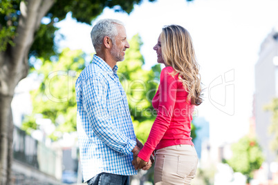 Romantic mature couple holding hands