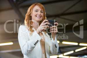 Pretty businesswoman using cellphone