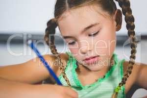 Schoolgirl doing homework in classroom