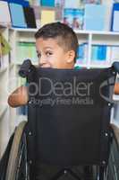 Disabled schoolboy in library