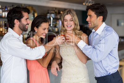 Group of friends toasting  glasses of tequila shot