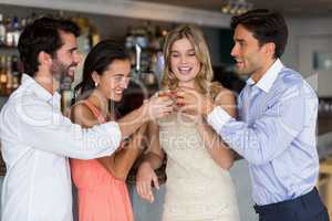 Group of friends toasting  glasses of tequila shot