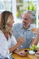Couple smiling while holding wineglass