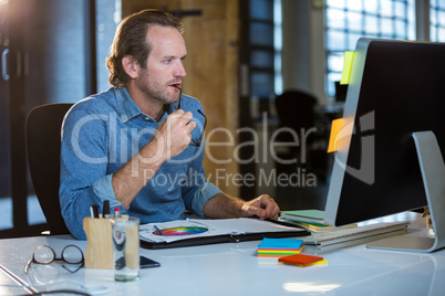 Concentrated businessman working at computer desk