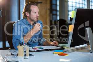 Concentrated businessman working at computer desk