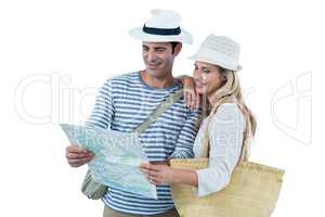 Couple reading map against white background