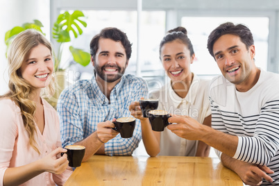 Group of happy friends holding cup of coffee