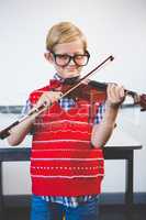 Portrait of schoolkid pretending to be music teacher