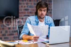 Creative businessman reading document