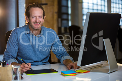Confident photo editor working at desk Confident photo editor working at desk