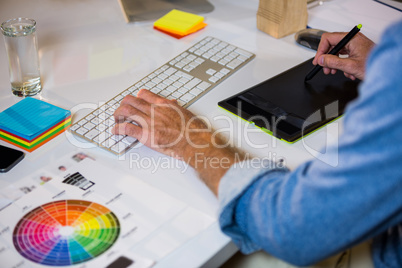 Photo editor working at desk in creative office