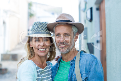 Happy mature couple by building