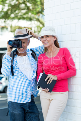 Man photographing while standing by wife