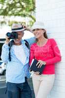 Man photographing while standing by wife