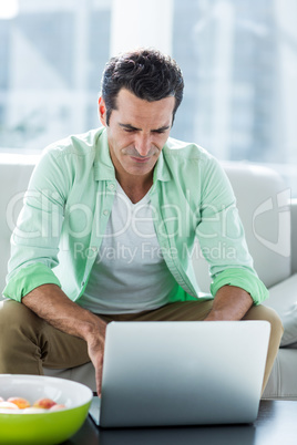 Man using laptop at home