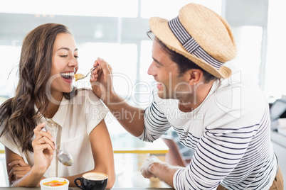 Smiling couple eating dessert