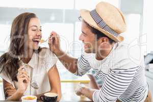 Smiling couple eating dessert