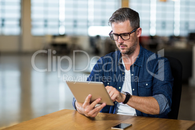 Focused man using digital tablet