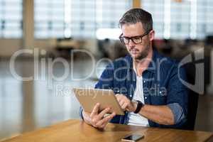 Focused man using digital tablet