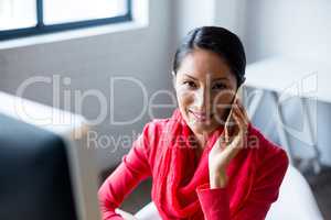 Businesswoman using mobile phone in office