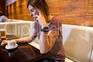 Woman talking on cellphone in restaurant