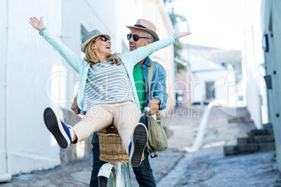 Couple enjoying while riding bicycle
