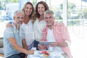 Mature couples by table in restaurant