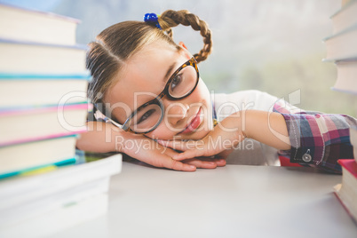 Close-up of schoolkid leaning on desk in classroom