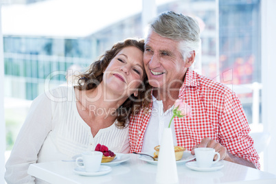 Smiling couple sitting at restaurant