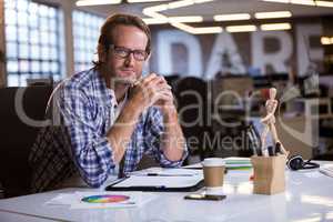 Creative businessman at desk in office