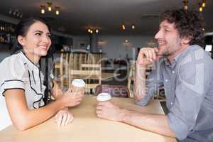 Couple interacting with each other in cafeteria