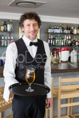 Waiter holding a tray with beer glass