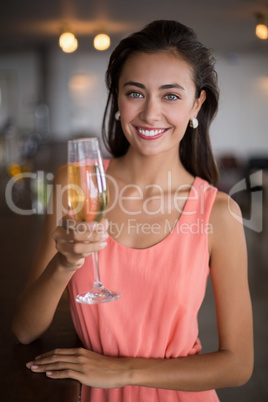 Portrait of smiling woman holding a champagne flute